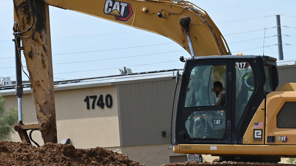 SAM operator in CAT excavator on site