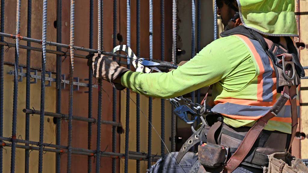 Ironworker tying rebar on wall form
